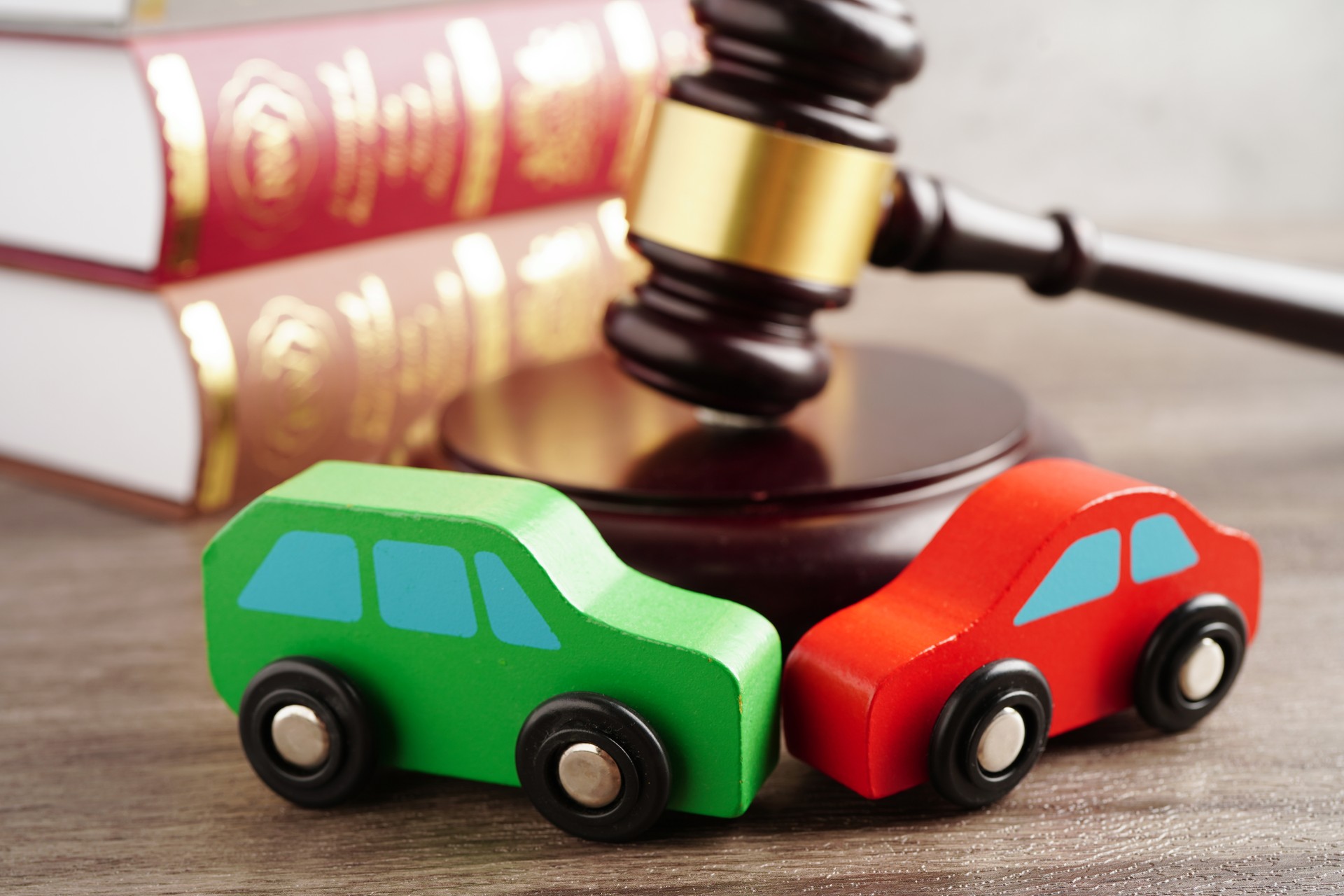 Car accident lawsuit and insurance, Judge hammer with car model.